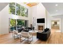 Bright living room features a fireplace, high ceilings, and large windows providing natural light at 490 Mount Paran Rd, Atlanta, GA 30327