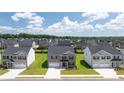 Aerial view of a neighborhood featuring well-maintained lawns and similar two-story homes with dark roofs at 628 Kimberwick Dr, Locust Grove, GA 30248