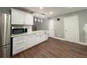 Bright kitchen showcases white cabinetry, sleek countertops, and modern stainless steel refrigerator at 1341 Beeblossom Trl, Lawrenceville, GA 30044