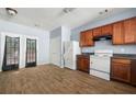 Bright kitchen featuring wood cabinets, a range hood, and appliances including a refrigerator at 4670 Ernest Dr, Forest Park, GA 30297