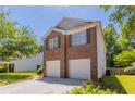 A two-story brick home with two-car garage and verdant front yard at 4915 Truitt Ln, Decatur, GA 30035