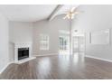 Bright living room features vaulted ceiling, a fireplace, wood floors and sliding glass doors leading to the backyard at 4915 Truitt Ln, Decatur, GA 30035