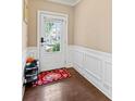 Neat foyer entry featuring paneled walls and beautiful hardwood floors at 4625 Cold Spring Court, Cumming, GA 30041