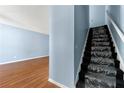 Bright entryway featuring wood floors and staircase with carpet at 2465 Brianna Dr, Hampton, GA 30228