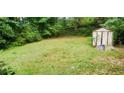 Spacious backyard featuring a storage shed and lush greenery at 3213 Jamaica Nw Rd, Atlanta, GA 30318
