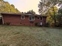 View of the brick exterior with windows and backyard including a satellite dish at 3213 Jamaica Nw Rd, Atlanta, GA 30318