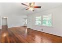 Inviting living room with gleaming hardwood floors, ceiling fan, and plenty of natural light at 4590 Sims Ct, Tucker, GA 30084