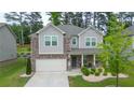 Charming two-story home with brick accents and a well-maintained landscaped front yard at 688 Saffron Blvd, Lawrenceville, GA 30045