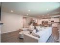 Open concept living room and kitchen area with a large sectional couch and breakfast table at 688 Saffron Blvd, Lawrenceville, GA 30045