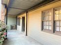 Side exterior view of property with covered patio and tan siding at 3079 Colonial Way # J, Atlanta, GA 30341