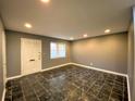 Inviting living room boasts dark tile floors, neutral paint, and a bright white front door at 3079 Colonial Way # J, Atlanta, GA 30341