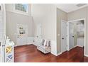 Elegant foyer with wainscoting, hardwood floors, and a view of the front door and a glimpse into the laundry room at 5010 Foxberry Ln, Roswell, GA 30075