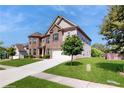 Two story home with brick facade, a two-car garage, and a well-maintained lawn at 205 Kestrel Cir, Covington, GA 30014