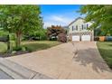Landscaped front yard of home with driveway leading to the two car garage at 21 Collins Dr, Douglasville, GA 30134
