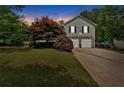 Charming two-story home featuring stone accents, a well-manicured lawn, and an attached two-car garage at 21 Collins Dr, Douglasville, GA 30134