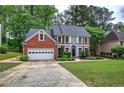 Attractive brick home with a neat front yard and beautiful landscaping, complemented by a paved driveway at 3186 Sail Winds Nw Dr, Acworth, GA 30101