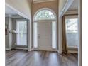 Bright foyer with a grand arched window above the door, complemented by modern wood-look flooring at 3186 Sail Winds Nw Dr, Acworth, GA 30101