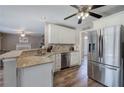 Bright kitchen featuring granite countertops, stainless steel appliances, and modern cabinetry at 3186 Sail Winds Nw Dr, Acworth, GA 30101