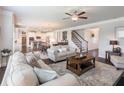 Spacious living room with hardwood floors, a ceiling fan, and an open floor plan at 4790 Epps Ln, Cumming, GA 30040