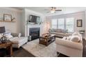 Cozy living room with a fireplace, plush seating, and hardwood floors at 4790 Epps Ln, Cumming, GA 30040