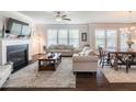 Bright living room with a fireplace, large windows, and hardwood floors at 4790 Epps Ln, Cumming, GA 30040