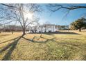 Expansive backyard featuring lush greenery and a charming deck perfect for outdoor enjoyment at 3241 Broadnax Mill Rd, Loganville, GA 30052