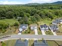 Scenic aerial view highlighting craftsman homes with lush green surroundings and mountain views at 3525 Brynhurst Dr, Cumming, GA 30028
