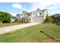Inviting two-story home with a landscaped front yard, long driveway, and attached garage at 3525 Brynhurst Dr, Cumming, GA 30028