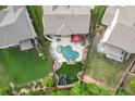 Aerial view of a backyard oasis with pool, lounge area, and well-maintained landscaping at 3939 Soft Wind Ter, Buford, GA 30518