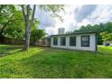 Backyard features a grassy area, a small deck, and mature trees at 1451 Brays Mill Trce, Lawrenceville, GA 30044