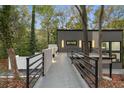 Modern home with standing seam and composite exterior featuring a cantilevered entrance walkway at 1153 Dawn View Nw Ln, Atlanta, GA 30327