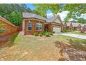 Beautiful, well-maintained brick home featuring manicured landscaping and an attached two-car garage at 2212 Nichols Valley Drive, Dacula, GA 30019