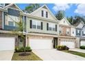 Well-maintained townhome featuring a stone facade, two-car garage, and welcoming curb appeal at 2140 Ravencliff Dr, Austell, GA 30168