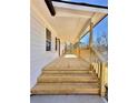 Inviting wooden porch with stairs and wooden railings on a charming single-story home at 2535 Impala Dr, Cumming, GA 30041