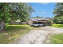 Single-story house features an open yard with a long gravel driveway and covered parking at 578 Laney Rd, Locust Grove, GA 30248