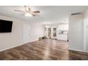 Open living room with hardwood floors, ceiling fan, and sliding glass doors to the deck at 578 Laney Rd, Locust Grove, GA 30248