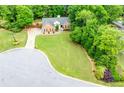 Aerial shot of the property showing a spacious lot, mature trees and the surrounding neighborhood at 3982 Ivory Gables Pl, Buford, GA 30519