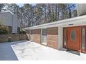 Exterior view featuring a brick facade, front door, and paved walkway at 1038 Seven Springs Cir, Marietta, GA 30068