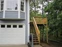 Home's exterior featuring a garage and wooden deck, providing an additional outdoor space at 27 Edgar Ct, Hiram, GA 30141