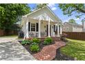 Charming home boasting a brick pathway, front porch seating, and a well-manicured lawn at 94 Glenn Se St, Atlanta, GA 30312