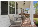 Covered front porch featuring a seating area with stylish wicker chairs and a view of the landscaped yard at 94 Glenn Se St, Atlanta, GA 30312