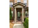 Elegant front entry featuring stately columns and lush landscaping at 10143 Windalier Way, Roswell, GA 30076
