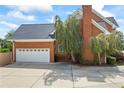 Spacious two-car garage attached to the brick home, surrounded by mature trees for added privacy at 1402 Bromley Dr, Snellville, GA 30078