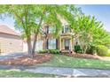 Charming two-story brick home featuring a well-manicured lawn and a two-car garage at 1584 Heartland Path, Hoschton, GA 30548