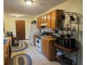 Functional kitchen with wooden cabinets and essential appliances in neutral tones at 162 Apple Valley Dr, Woodstock, GA 30188