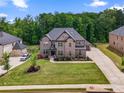 Charming brick two-story home with landscaped front yard and a spacious driveway at 317 Basel Way, Hampton, GA 30228