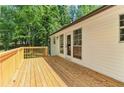 Inviting deck with natural wood finish and white siding, perfect for relaxing or entertaining outdoors at 7160 Royston Way, Cumming, GA 30028