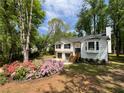 Charming two-story home with a bay window, flower beds, and a double-car garage at 7160 Royston Way, Cumming, GA 30028