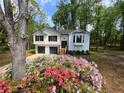 Charming two-story home with a bay window, flower beds, and a double-car garage at 7160 Royston Way, Cumming, GA 30028