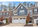 Charming two-story townhouse with a two-car garage and paved driveway at 305 Duval Dr, Alpharetta, GA 30009